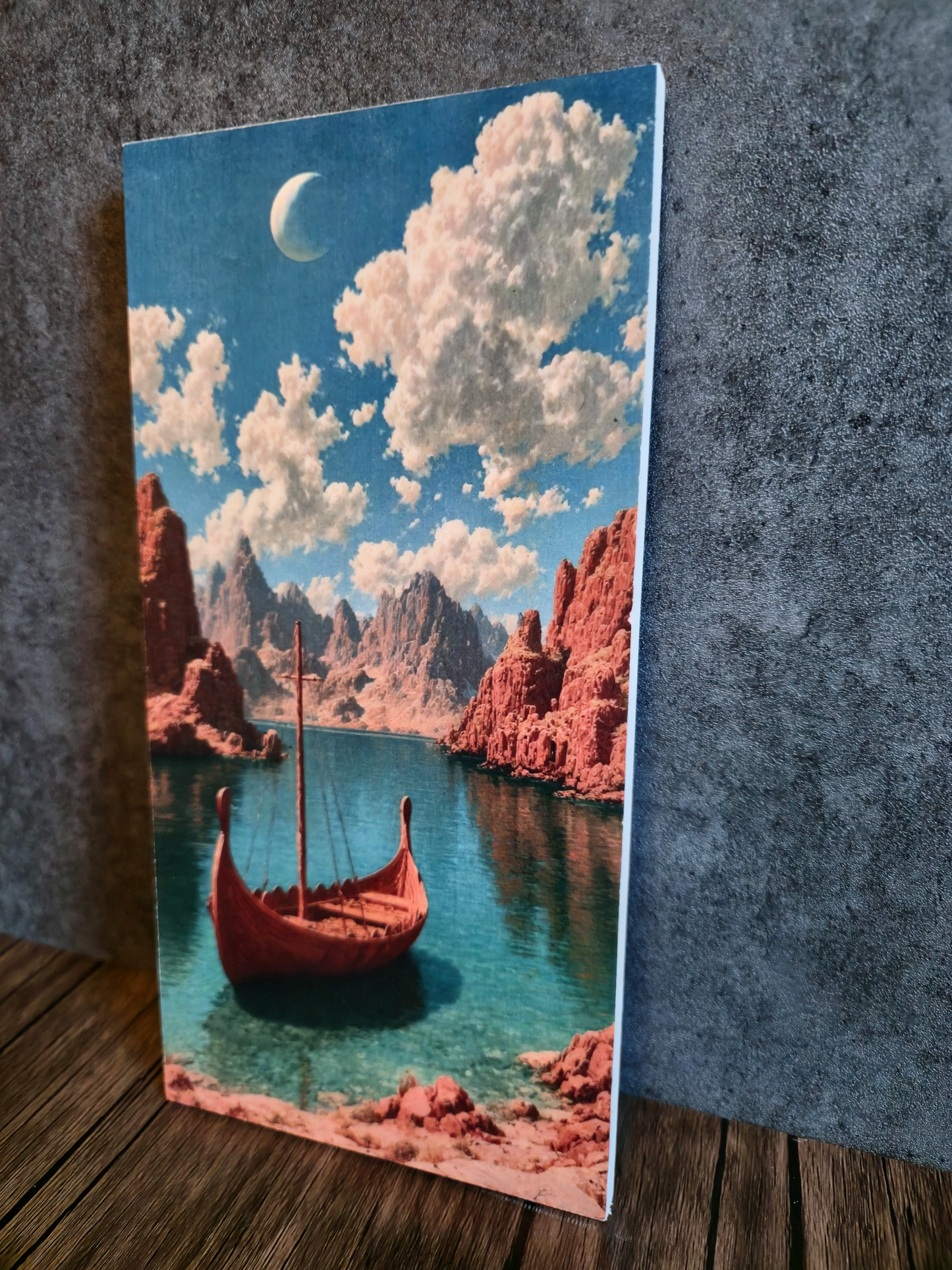 Canvas print of a red boat on a lake with red rock formations and a blue sky.