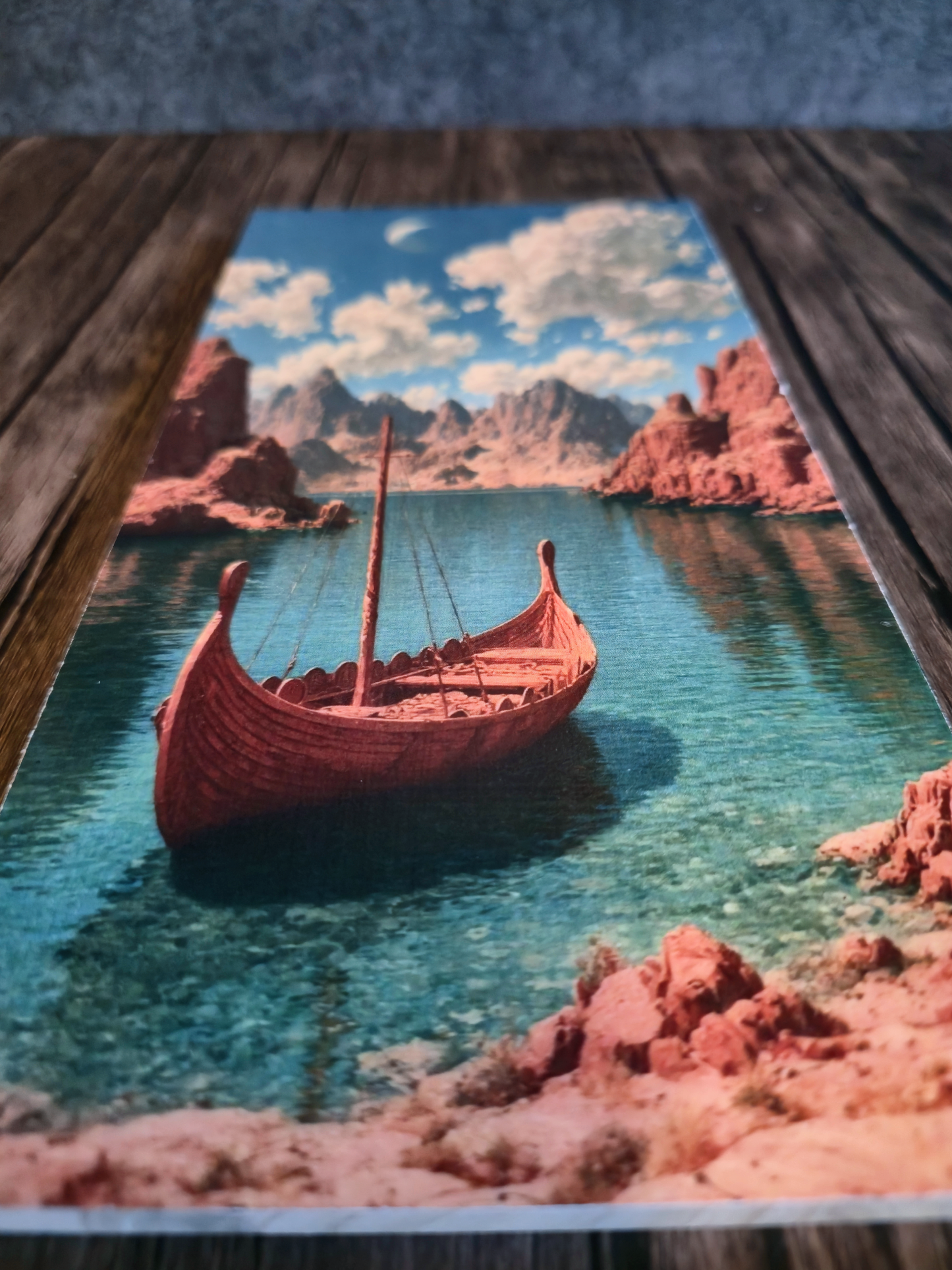 Viking ship in a scenic setting with mountains and water on a wooden surface