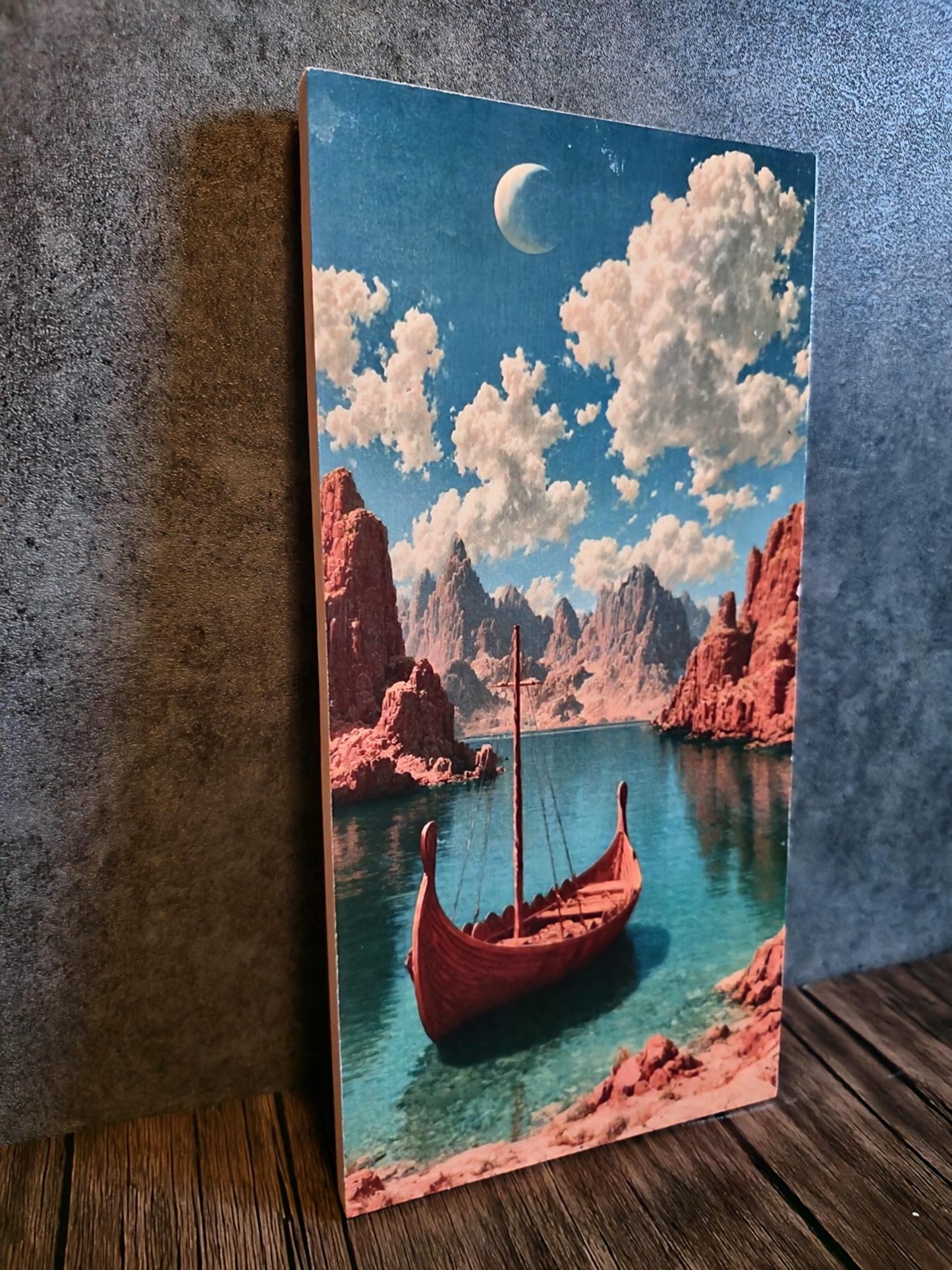 Canvas print of a red boat on a lake with mountains and clouds.