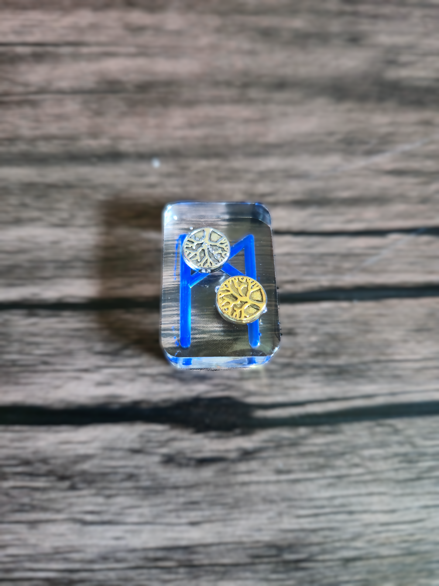 tree of life beads inside a clear Norse runestone with blue Viking symbol