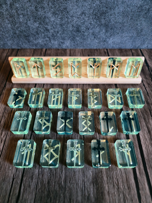 Set of transparent green letter tiles on a wooden board against a dark background