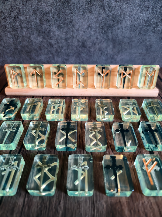Set of clear crystal blocks with engraved symbols on a wooden stand against a dark background