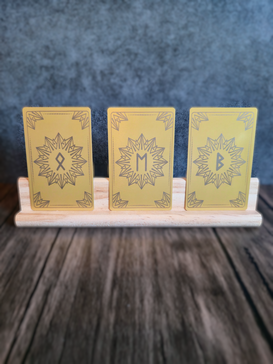 Three yellow cards with star designs on a wooden stand against a dark background