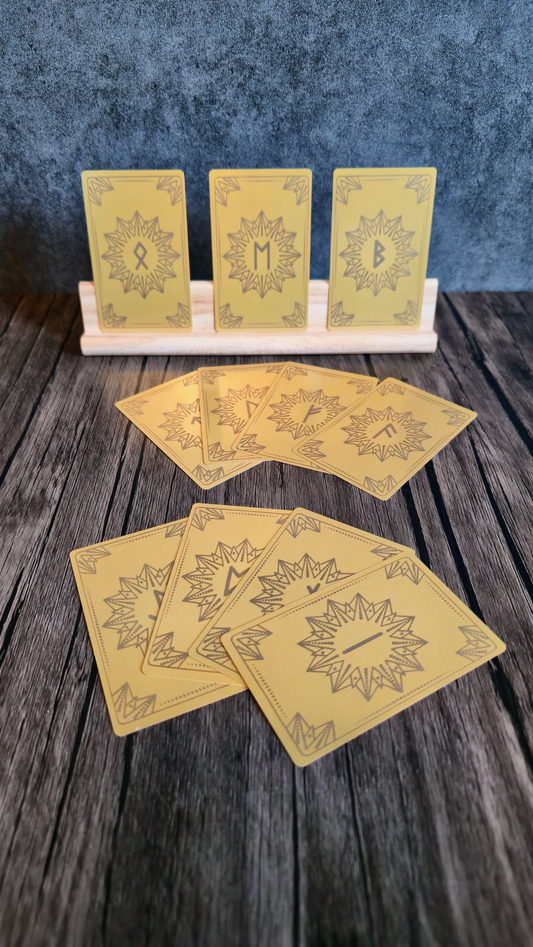 Set of yellow rune cards on a wooden surface with a blue textured background