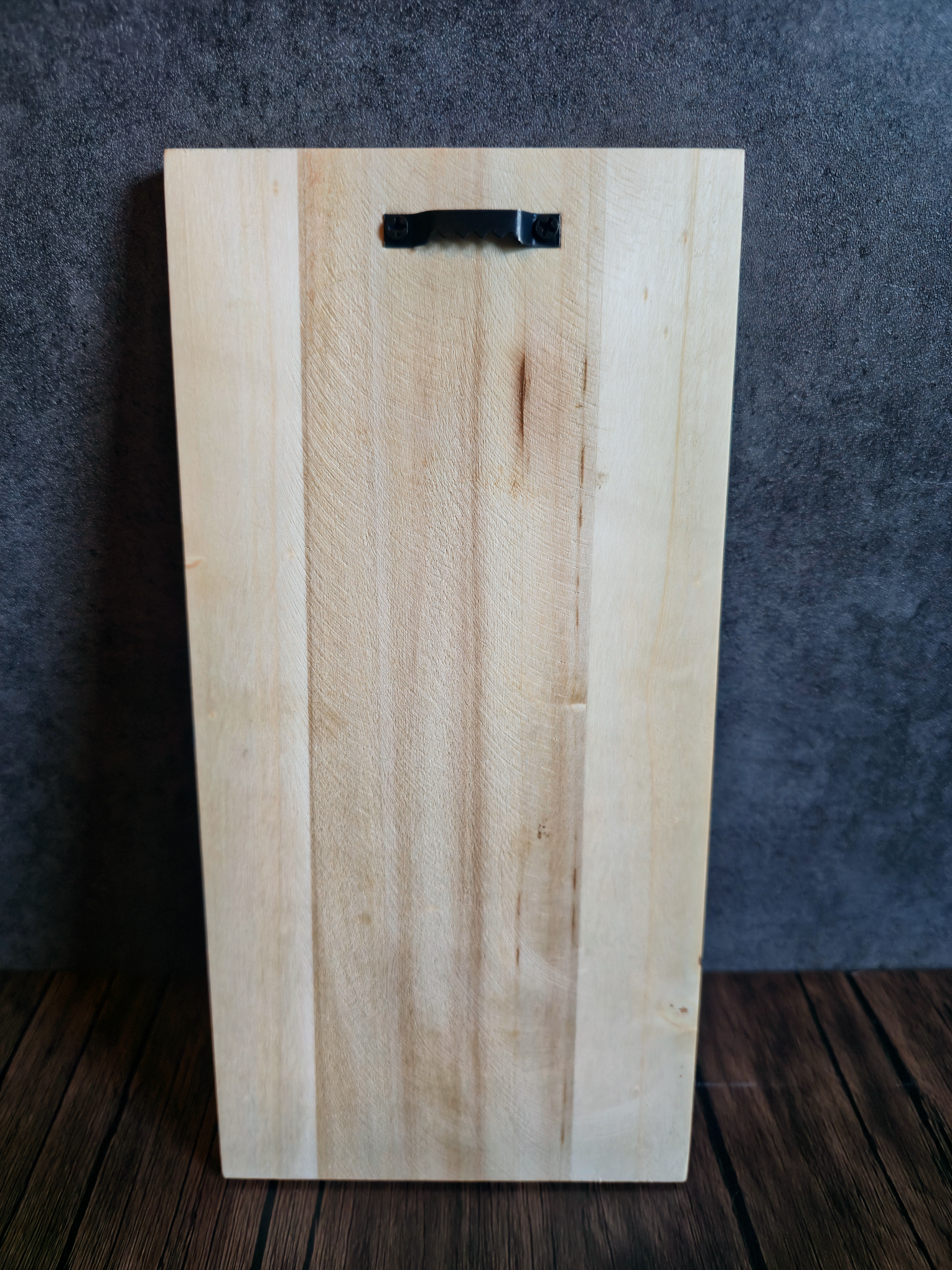 wooden plank with hanger on wood table with grey background