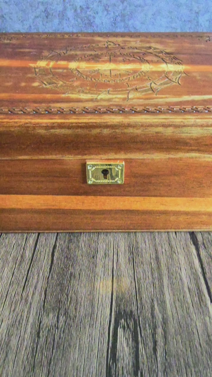 video showing hand crafted box with Viking runes and world eater, brass fittings with brass lock