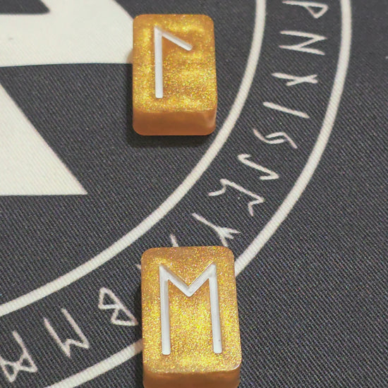 Video scanning overtop of the Gold ingot set highlighting the gold colors and showing the white rune symbols of each.  Laid neatly in a row on top of a mat rune mat.