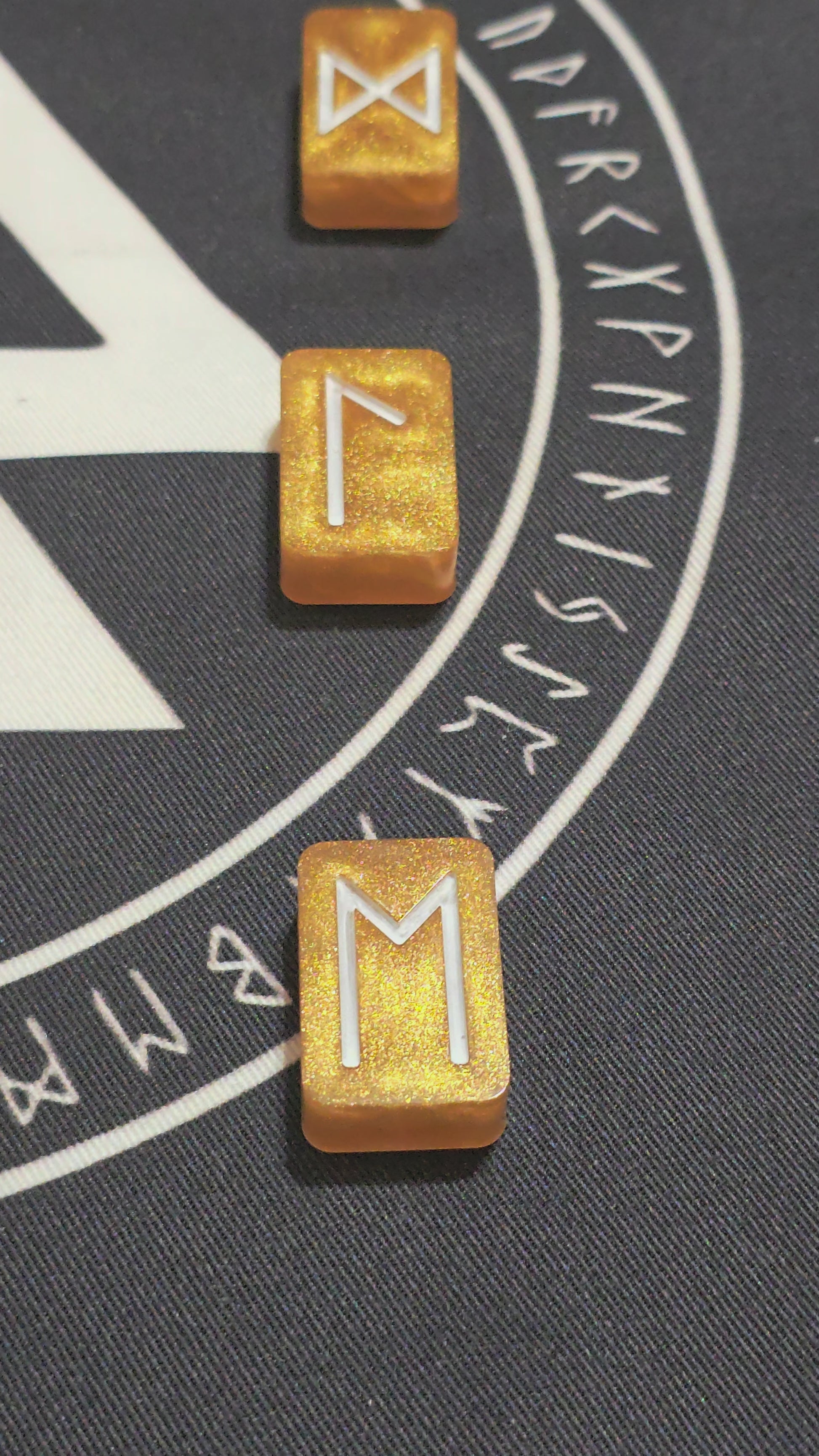 Video scanning overtop of the Gold ingot set highlighting the gold colors and showing the white rune symbols of each.  Laid neatly in a row on top of a mat rune mat.