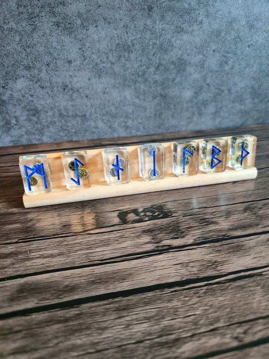 Decorative item with Viking runic symbols on a wooden stand against a gray background